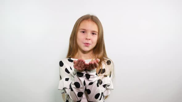 Sweet blonde young girl sending air kiss. 