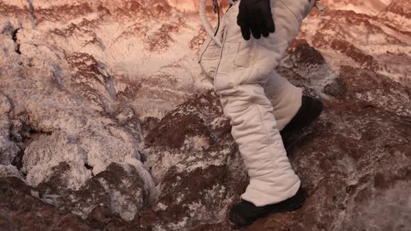 the Astronaut Walks Cautiously on the Surface of the Planet