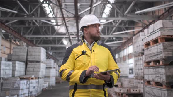 Worker Male Warehouse Worker Engineer Man in A Helmet Working on The Construction Site