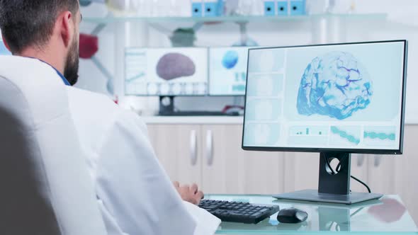 Over the Shoulder Shot of Doctor in Research Facility Looking at 3D Brain Scan