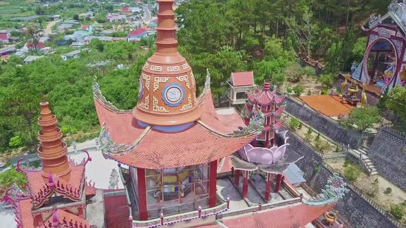 Flycam Shows Red Temple Roof Among Buildings Tropical Plants