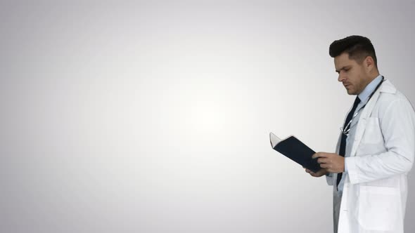 Concentrated Medical Doctor Reading Documentation While Walking on Gradient Background.