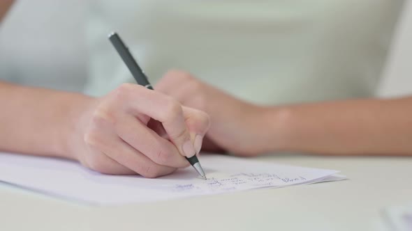 Close Up of Female Hand Writing on Paper