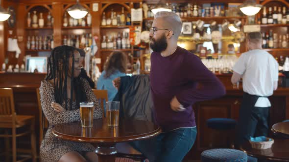 Multiethnic Couple Having Date in Modern Beer Pub