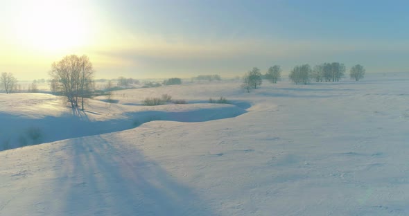 Aerial View of Cold Winter Landscape Arctic Field Trees Covered with Frost Snow Ice River and Sun