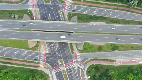 Aerial view over a highway interchange during peak hour traffic.