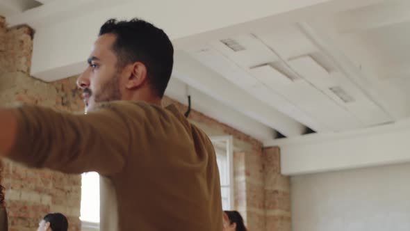 Positive Middle Eastern Man Dancing at Group Class