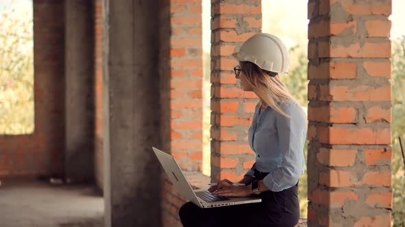 Real Estate Building Project Manager. Woman Architect In Helmet Inspecting Building. Civil Engineer.