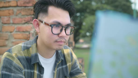 Traveler Asian man direction and looking on location map while spending holiday trip at Ayutthaya