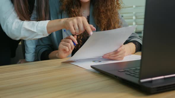 Close up female hands business people women in office doing paperwork.