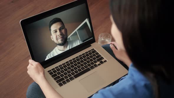 Young Woman Smiling While Videoconferencing at Home During Coronavirus Self Quarantine