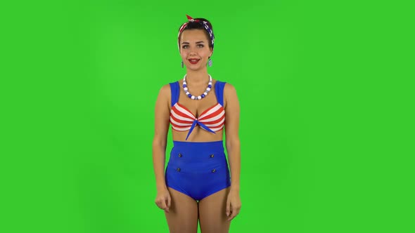 Beautiful Girl in a Swimsuit Is Pointing Up Fingers. Green Screen
