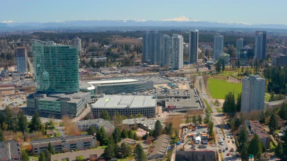 Stunning Aerial View of Surrey Central City Mall in BC Canada in UHD on a Sunny Day. Mount Baker and