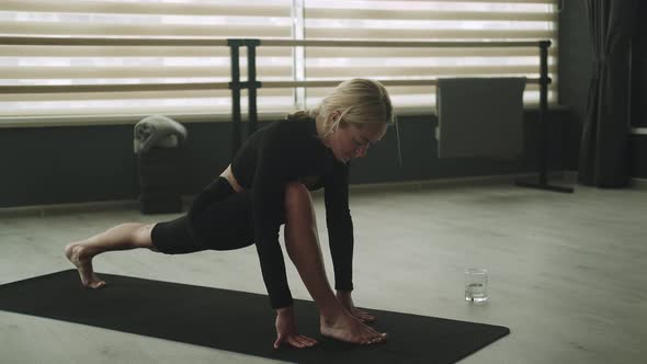 Young Woman is Doing Yoga in a Room Filled with Light