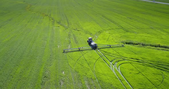 Upper View Tractor Trailer Makes Circle Traces on Fields