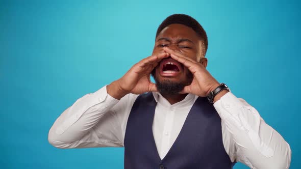 African American Man Put His Hands to His Face and Shout Against Blue Background