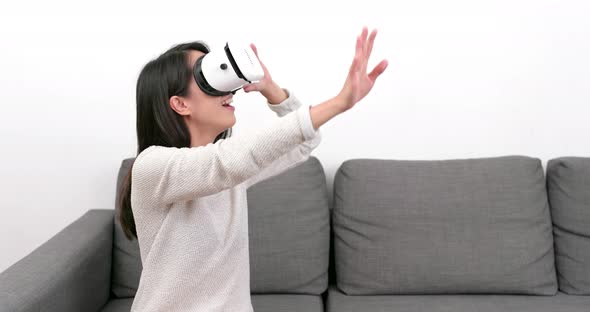Woman looking with VR device at home