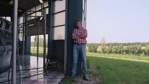 Farmer Inspecting Milk Parlour at Countryside