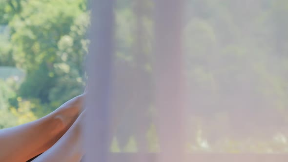 Woman on Balcony Listening to Music on Smartphone and Enjoying Summer Morning