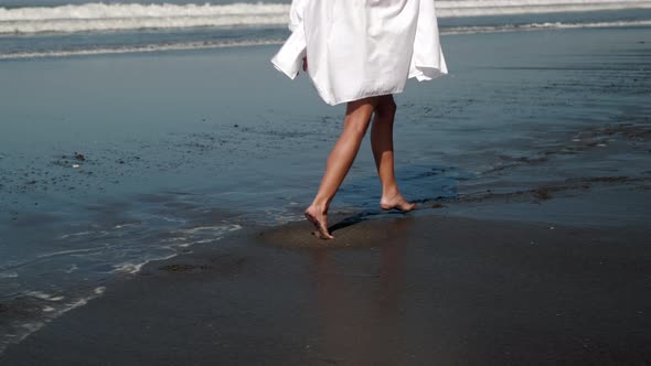 Carefree Girl Enjoying Freedom and Running Along the Ocean Coast