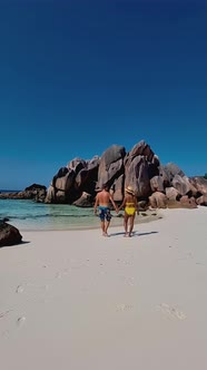 Men and Women on the Beach of Anse Cocos La Digue Seychelles Tropical Beach During Luxury Vacation