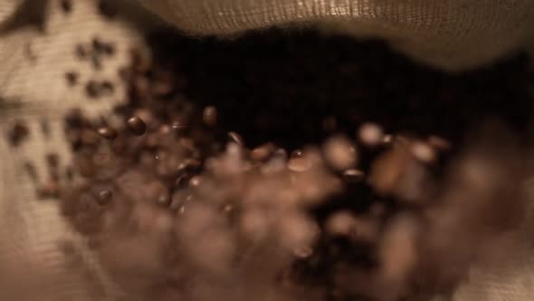 Coffee Beans are Falling on Burlap in Slow Motion