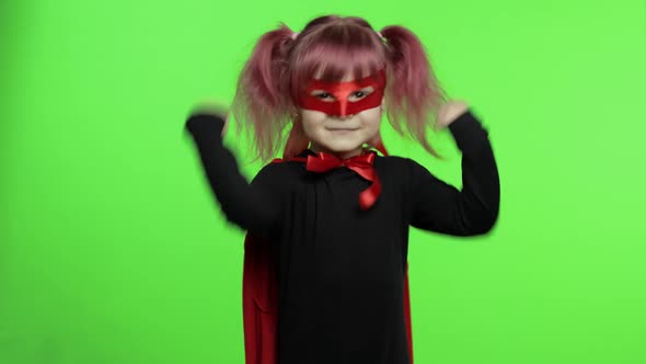 Funny Child Girl in Costume and Mask Plays Super Hero. National Superhero Day