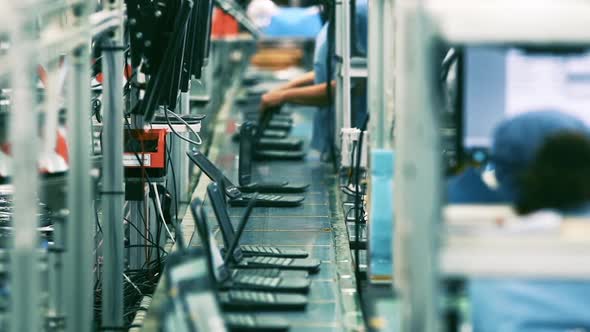 Assembly Line Workers, Laptop Manufacturing Plant.