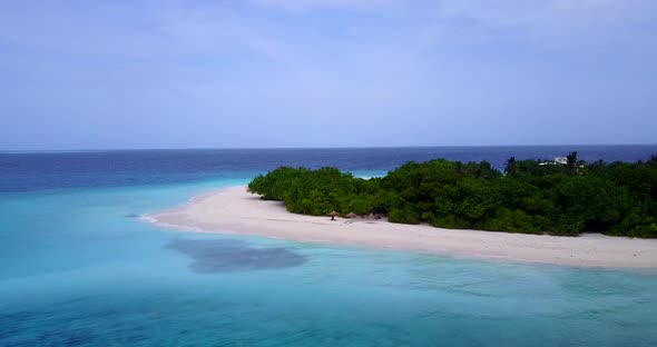 Wide flying travel shot of a sandy white paradise beach and aqua blue water background in best quali