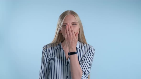 Young Lady Sending an Air Kiss and Blinking with One Eye