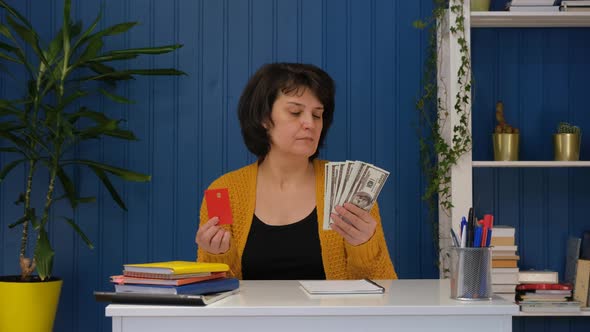 Woman is Holding Credit Card and Money and Choose Credit Card
