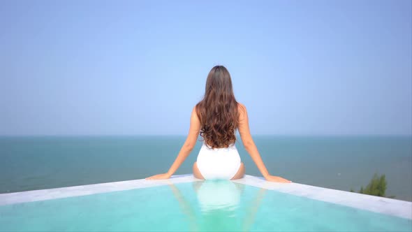 Young asian woman enjoy around outdoor swimming pool for leisure