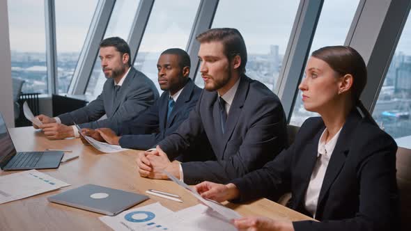 Young corporate leader with his team at a meeting with partners