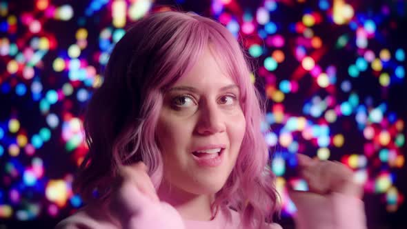 Pink-Haired Party Girl Dancing with Colorful Lights in Background