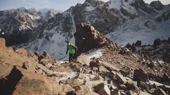 Man Running at the Mountain with Snow