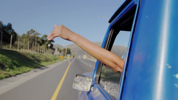 Young woman on a road trip in pick-up truck