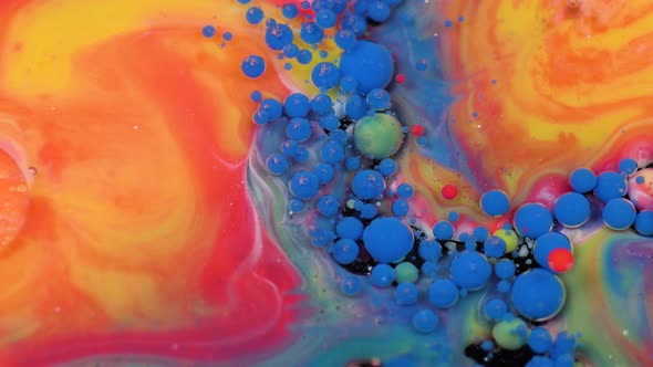 Amazing Multicolored Bubbles of Paint on the Oil Surface. Paint in Oil.