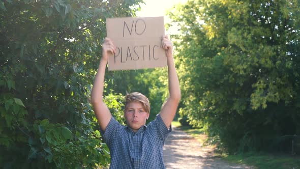 a Young Teenager of Caucasian Ethnicity a Man in a Blue Shirt Holds a Piece of Cardboard Box with