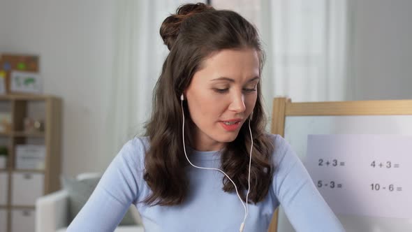 Teacher in Earphones Having Online Class at Home