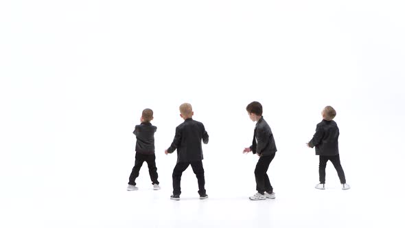 Kids Are Dancing a Modern Dance on the White Background in Black Leather Jackets and Jeans