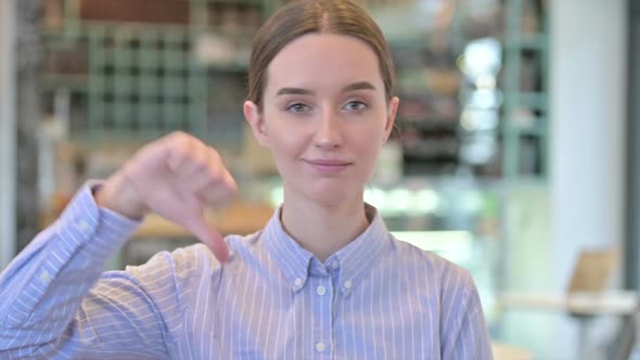 Portrait of Thumbs Down By Disappointed Young Businesswoman