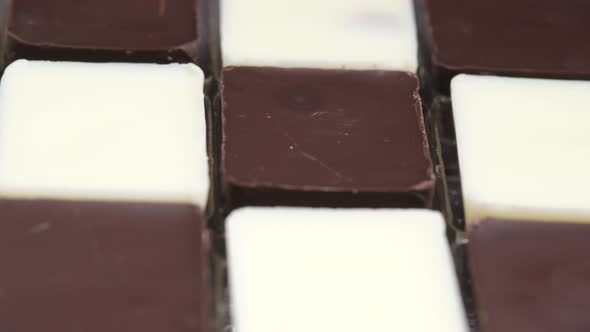 Dark and White Chocolate in a Box on Gray Background