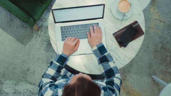 Top View on Adult Man Work on Laptop at Cafe