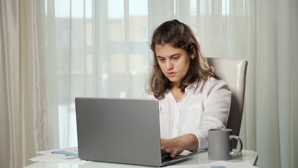 Disabled Woman Freelancer Drinks Tea Working on Computer