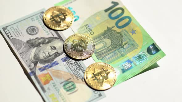 Digital Cryptocurrency Gold Bitcoin Lying Between US Dollar and Euro Banknotes