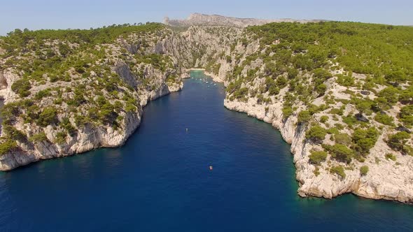 Aerial travel drone view of clear green water, cliffs of Cassis, Mediterranean Sea, Southern France.