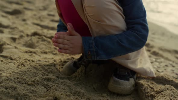 Kid Playing Beach Sand By Sea