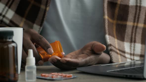 Sick Black Man Taking Medicine Pills Holding Tube Indoor Closeup