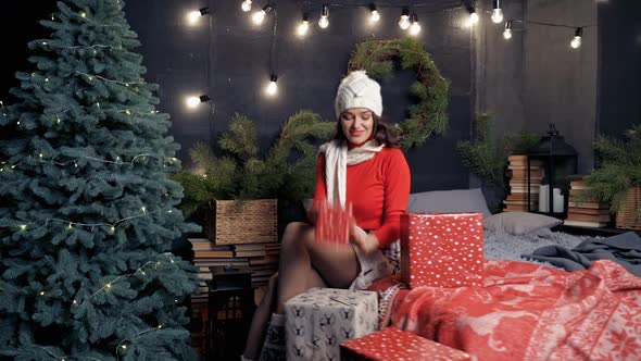 Beautiful young woman throving new year presents in air