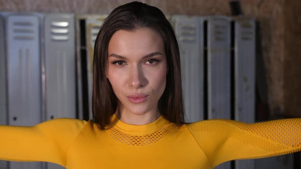 Young Sports Girl in a Yellow Sports Uniform Get Ready for a Workout